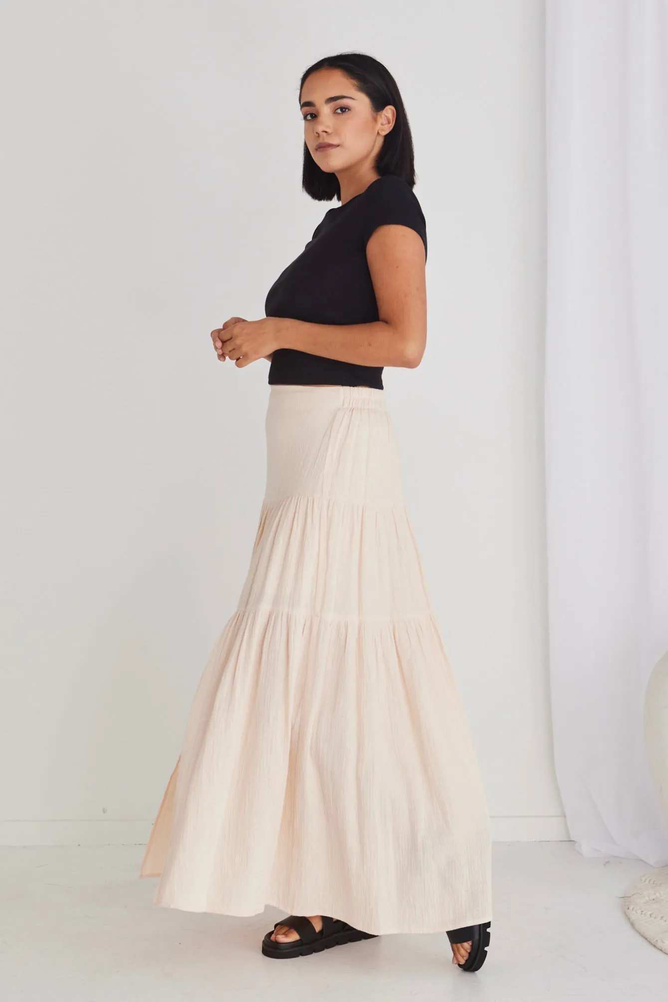 Sure, heres an optimized title with modifiers for the e-commerce product:

Chic Alive Cream Tiered Maxi Skirt with Elastic Back in Soft Muslin

This title highlights the style, color, and key features of the skirt.
